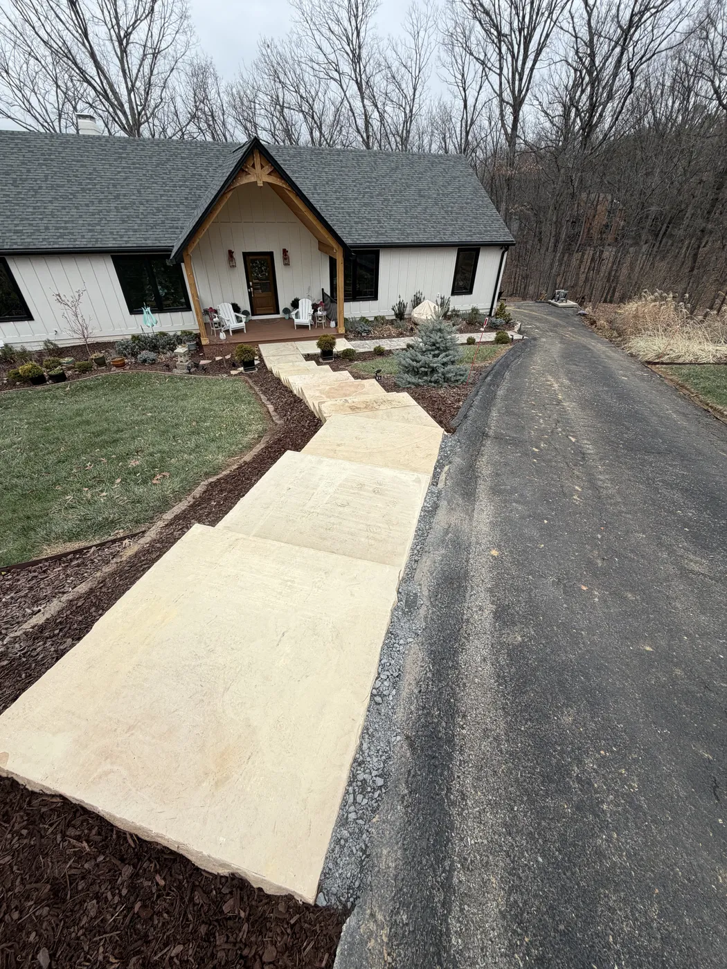 Stone steps connecting sidewalk to driveway at Hunting Hill
